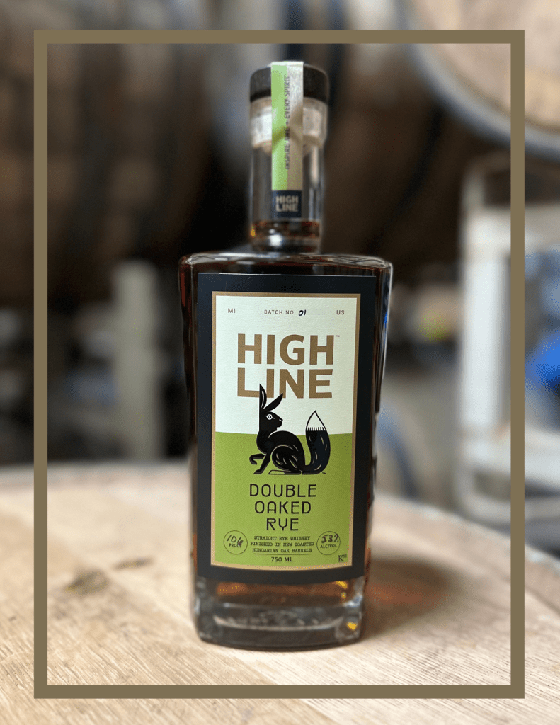 Highline whiskey bottle on top of a whiskey barrel