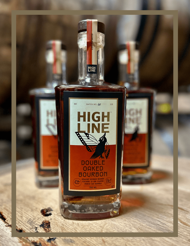 Bourbon bottles sitting on a whiskey barrel